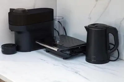 a black coffee maker sitting on top of a counter at Athens Luxury center Aparts F&G in Athens