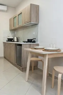 a kitchen with a wooden table and a counter top at Athens Luxury center Aparts F&G in Athens