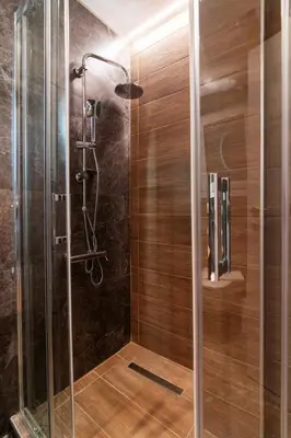a shower with a glass door in a bathroom at Luxury Boutique Suite w Balcony 5 min Metro in Athens