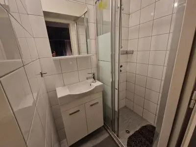 a bathroom with a shower and a sink and a mirror at AIOLOU st - 2 BDR APT - NetFlix in Athens