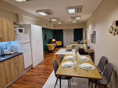 a kitchen and dining room with a table and chairs at AIOLOU st - 2 BDR APT - NetFlix in Athens