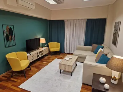a living room with a couch and a tv at AIOLOU st - 2 BDR APT - NetFlix in Athens