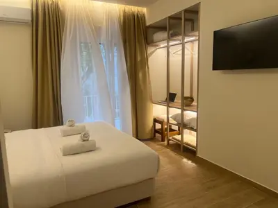 a bedroom with a bed and a flat screen tv at Athens Ilisiam in Athens