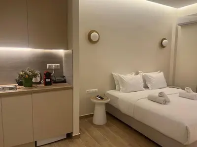 a hotel room with a bed and a counter at Athens Ilisiam in Athens