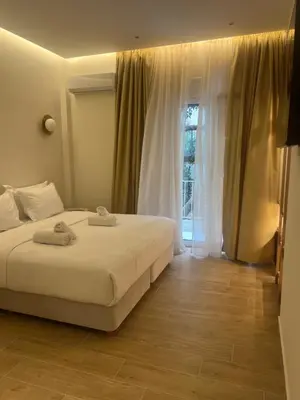 a bedroom with a large bed and a window at Athens Ilisiam in Athens