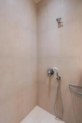 a shower with a shower head in a bathroom at Beach Bliss Studio in Athens