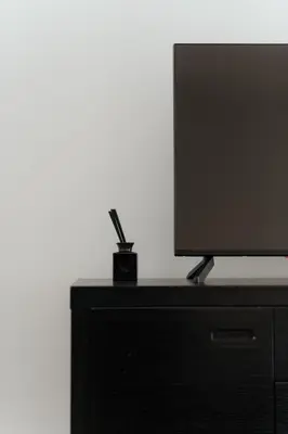 a flat screen tv sitting on top of a dresser at Beach Bliss Studio in Athens