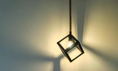 a black lantern hanging from a wall with a light at Spacious Rooftop Apt in Central Athens with Sunset Balcony in Athens