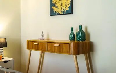 a wooden table with two vases on top of it at Spacious Rooftop Apt in Central Athens with Sunset Balcony in Athens