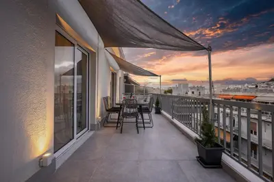 a balcony with a table and chairs on a building at Spacious Rooftop Apt in Central Athens with Sunset Balcony in Athens