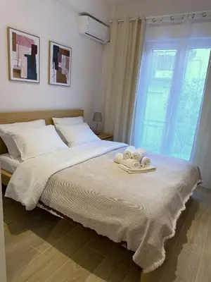 a bedroom with a bed with two towels on it at Piraeus 2 bedrooms apartment in Piraeus