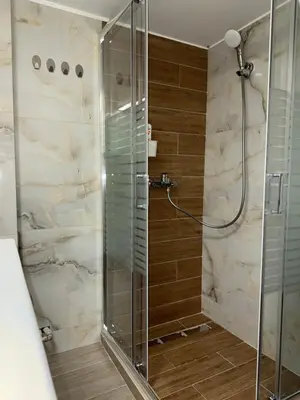a shower with a glass door in a bathroom at Piraeus 2 bedrooms apartment in Piraeus