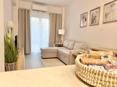 a living room with a couch and a table at Piraeus 2 bedrooms apartment in Piraeus