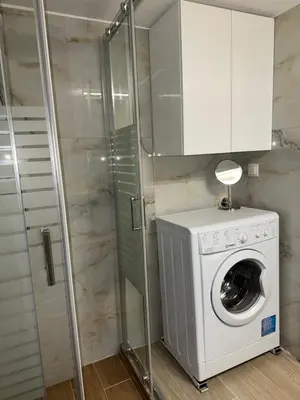 a washing machine in a bathroom with a shower at Piraeus 2 bedrooms apartment in Piraeus
