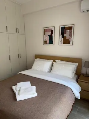 a bedroom with a bed with two towels on it at Piraeus 2 bedrooms apartment in Piraeus