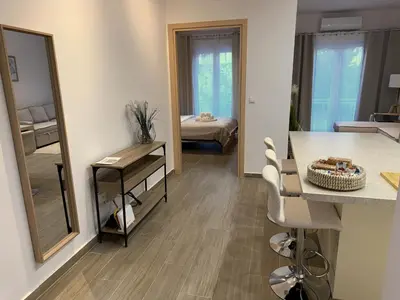 a living room with a table and a mirror at Piraeus 2 bedrooms apartment in Piraeus