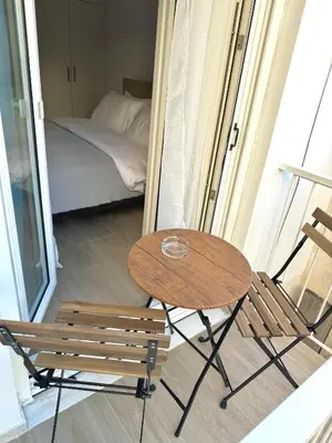 a table and a chair and a bed in a room at Piraeus 2 bedrooms apartment in Piraeus