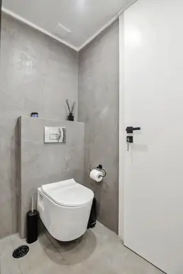 a bathroom with a white toilet in a room at Stylish Escape Suite in Athens in Athens
