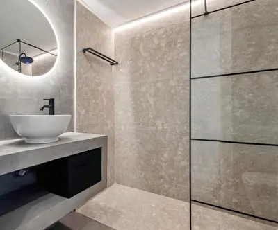 a bathroom with a sink and a glass shower at Stylish Escape Suite in Athens in Athens