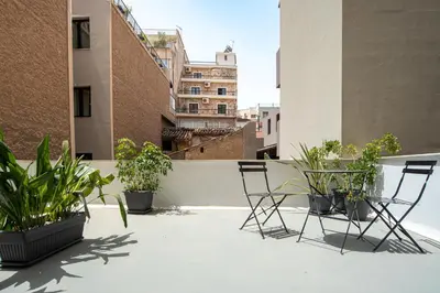a patio with chairs and plants on a roof at Stylish Escape Suite in Athens in Athens