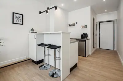 a kitchen with a counter and stools in a room at Stylish Escape Suite in Athens in Athens