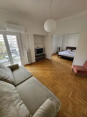 a living room with a couch and a bed at Central View Apartment in Athens