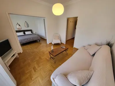 a living room with a couch and a bed at Central View Apartment in Athens
