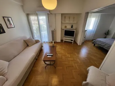 a living room with a couch and a coffee table at Central View Apartment in Athens