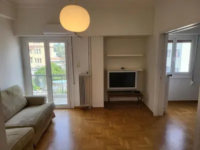 a living room with a couch and a flat screen tv at Central View Apartment in Athens