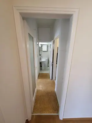 a hallway leading to a bathroom with a toilet at Central View Apartment in Athens