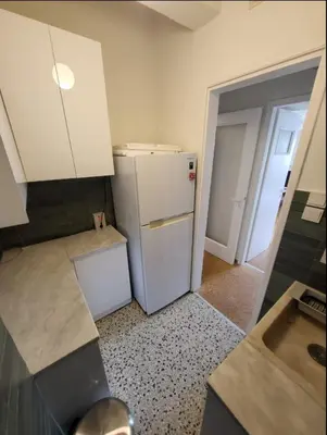 a kitchen with a white refrigerator in a room at Central View Apartment in Athens