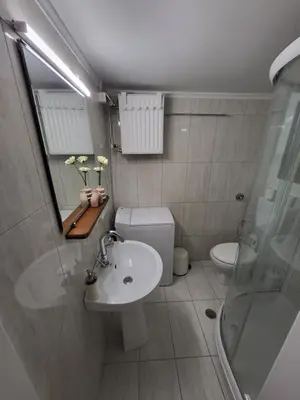 a bathroom with a toilet and a sink and a shower at Central View Apartment in Athens