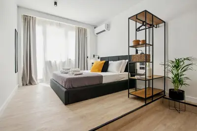 a bedroom with a bed and a book shelf at Exquisite Athens Center Suite in Athens
