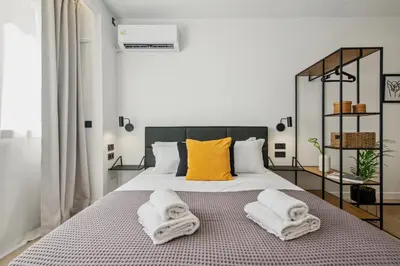 a bedroom with a large bed with towels on it at Exquisite Athens Center Suite in Athens