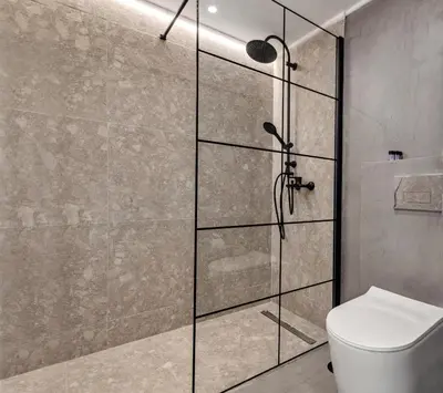 a shower stall with a toilet in a bathroom at Exquisite Athens Center Suite in Athens