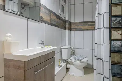 a bathroom with a toilet and a sink at Dreamy Cove, Artistic Hideaway near Floisvos 1BD in Athens