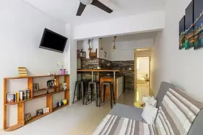 a living room with a couch and a kitchen with a table at Dreamy Cove, Artistic Hideaway near Floisvos 1BD in Athens