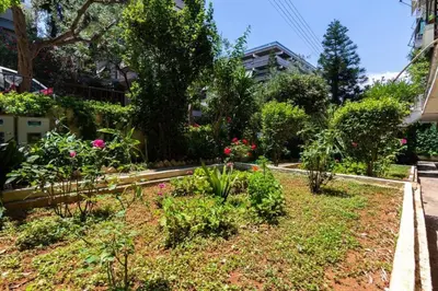 a garden with flowers and plants on a street at Dreamy Cove, Artistic Hideaway near Floisvos 1BD in Athens