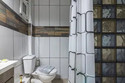 a bathroom with a toilet and a sink at Dreamy Cove, Artistic Hideaway near Floisvos 1BD in Athens