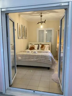 a bedroom with a bed and a large glass window at Athens Central Hideout next to Acropolis in Athens