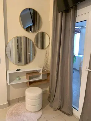 a bathroom with three circular mirrors and a stool at Athens Central Hideout next to Acropolis in Athens