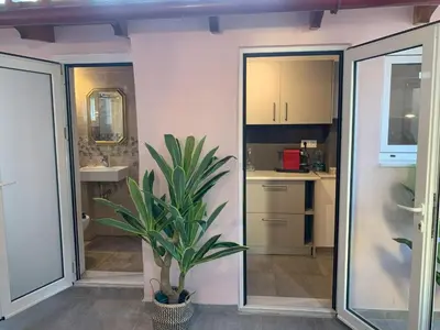 a bathroom with a plant in the middle of a room at Athens Central Hideout next to Acropolis in Athens