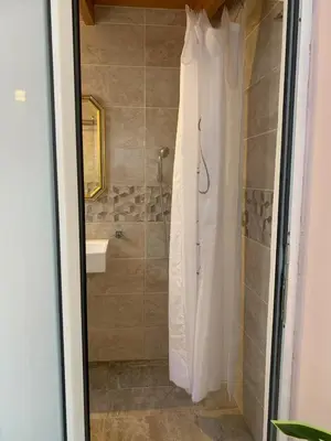 a bathroom with a shower with a shower curtain at Athens Central Hideout next to Acropolis in Athens