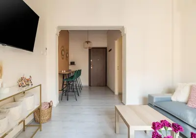 a living room with a couch and a table at Emilia Athens in Athens