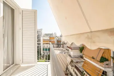an apartment balcony with a view of a city at Emilia Athens in Athens