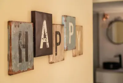 a group of letters hanging on a wall at Emilia Athens in Athens