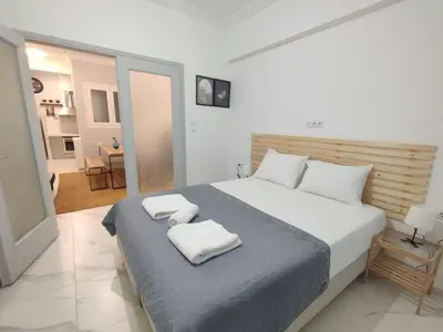 a bedroom with a bed with two towels on it at Athens Central Stay, 3BD Apartment, 3min Metro in Athens