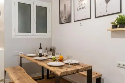 a wooden table with plates and wine bottles on it at Athens Central Stay, 3BD Apartment, 3min Metro in Athens