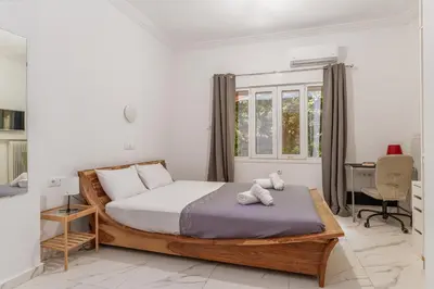 a bedroom with a bed and a desk and a window at Athens Central Stay, 3BD Apartment, 3min Metro in Athens