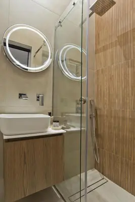 a bathroom with a sink and a mirror at Stylish Ilisia Stay Luxury Fully Reno 2BR, 2BA Apt in Athens